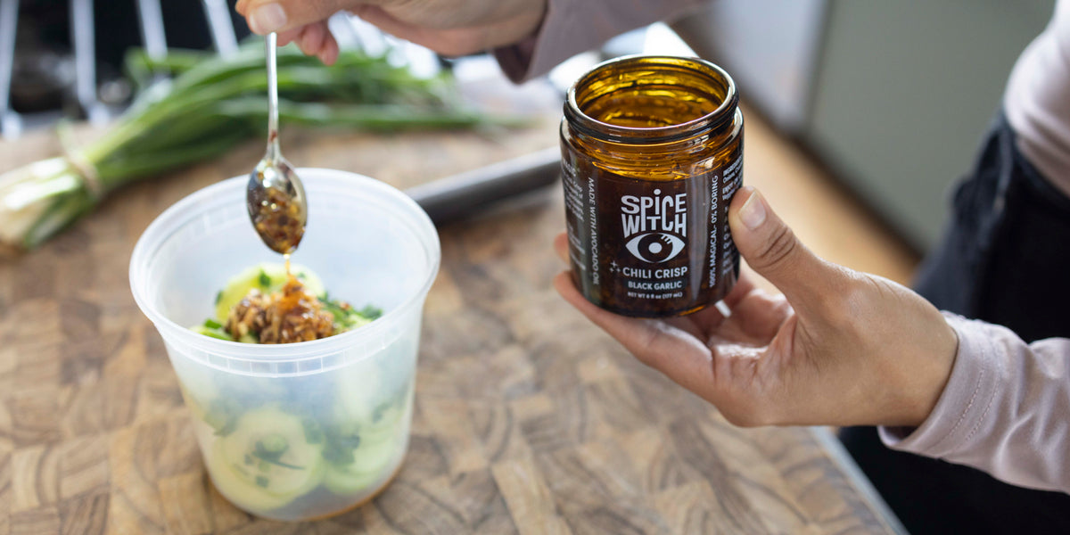 Spooning Spice Witch Black Garlic Chili Crisp in the kitchen