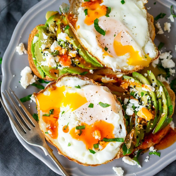 Avocado toast topped with Spice Witch Chili Crisp and a fried egg