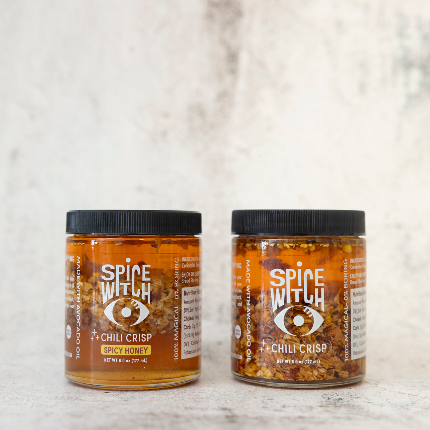 
                  
                    Bundle of Spice Witch Chili Crisp jars displayed with vibrant, spicy ingredients like chili peppers, garlic, black garlic, and a drizzle of spicy honey, highlighting the bold and flavorful textures of the product
                  
                