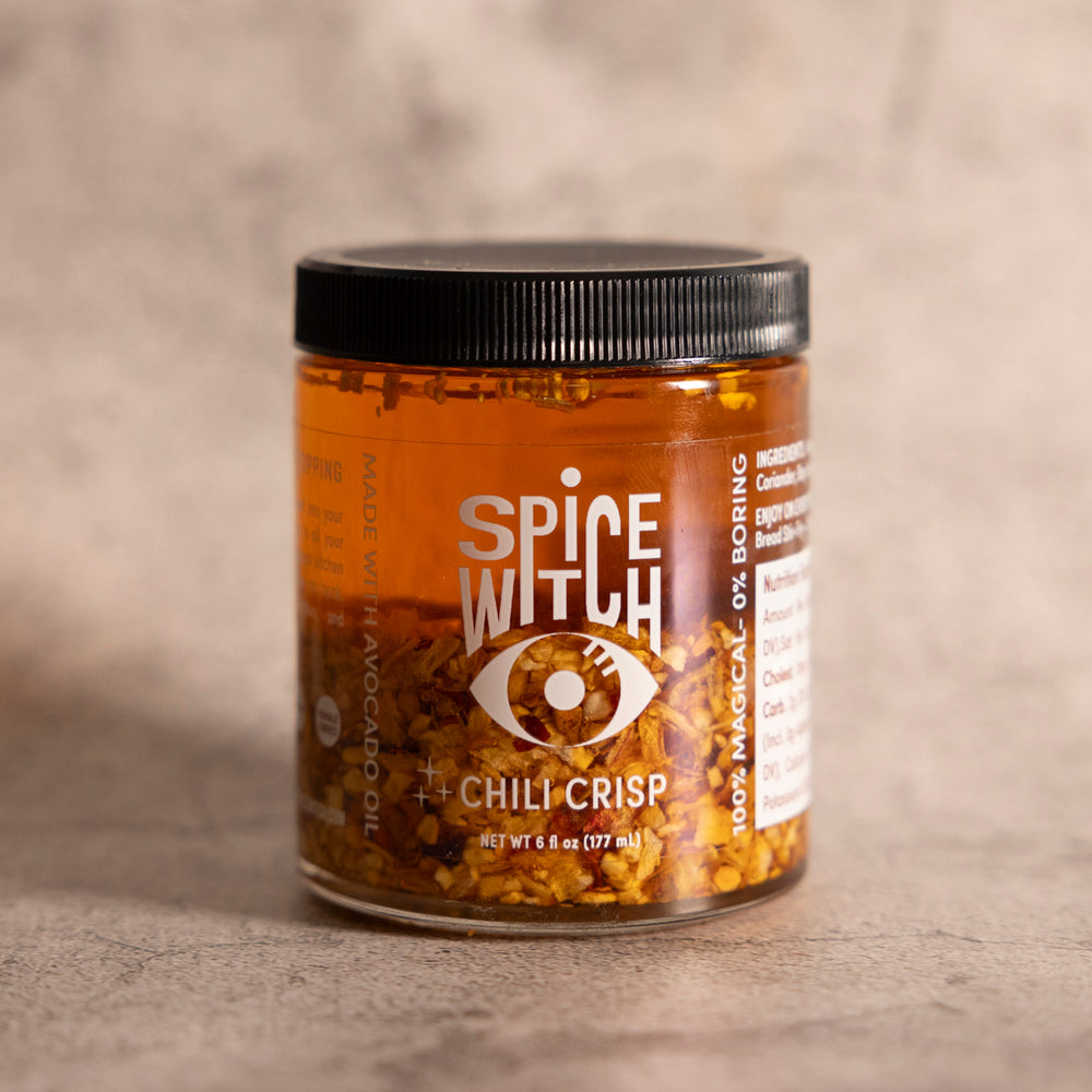 Spice Witch Chili Crisp in avocado oil base with garlic, ginger, dried onions, shallots, chili flakes, and sea salt. Perfect for adding flavorful crunch to pizza, pasta, and more. Versatile, healthy, and delicious condiment