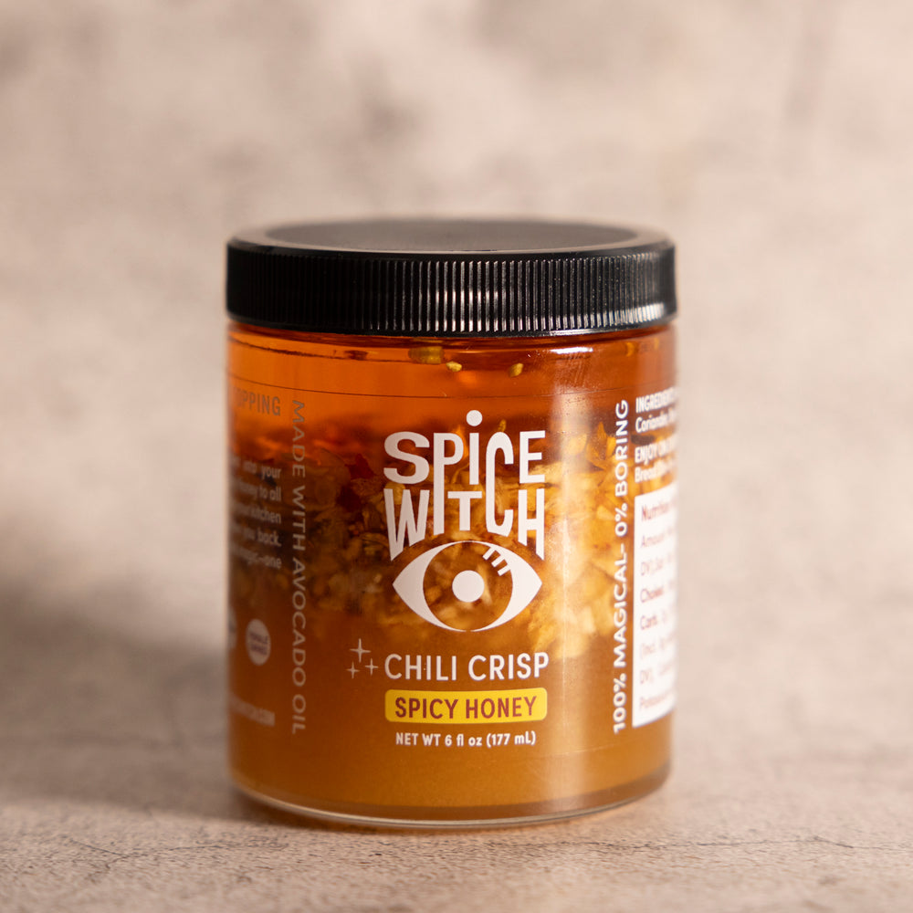 Jar of Spice Witch Chili Crisp with a Spicy Honey Twist, highlighting its unique combination of spicy, crunchy, and sweet flavors. Perfect for enhancing pizza, pasta, grilled meats, and more.